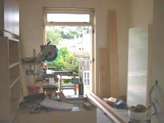 Standing in the new kitchen, looking through the dining nook and out the french doors